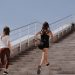 Two women running up stairs outdoors, embodying fitness and wellness.